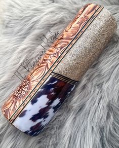 an animal print brush laying on top of a furry surface