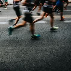 a group of people running down the street