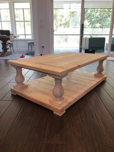 a wooden table sitting on top of a hard wood floor