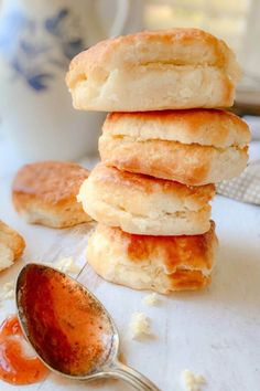 a stack of biscuits sitting on top of a table next to a spoon