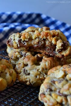 chocolate chip cookies stacked on top of each other in front of a blue and white checkered napkin