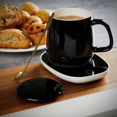 a cup of coffee and some muffins on a table