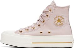 High-top canvas sneakers in pink. · Rubber cap toe · Lace-up closure · Logo patch and eyelets at inner side · Mesh lining · OrthoLite cushioning insole · Logo patch at heel · Treaded rubber platform sole · Platform: H1.5 Supplier color: Flush Stone/Egret/Gold Pink Chuck Taylors, Pink Chucks, Chuck Taylor All Star Lift, Converse Pink, Top Sneakers Women, Converse Sneakers, Sneaker Collection, Sportswear Women, Canvas Sneakers