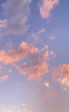 an airplane is flying high in the sky at sunset or dawn with clouds above it