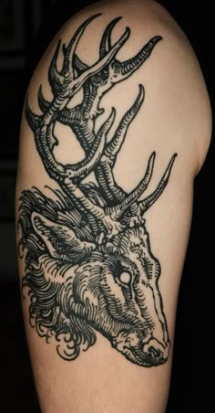 a man with a deer head tattoo on his arm