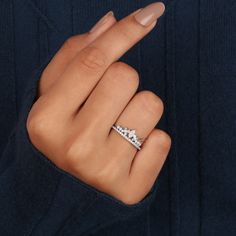 a woman's hand with a diamond ring on it