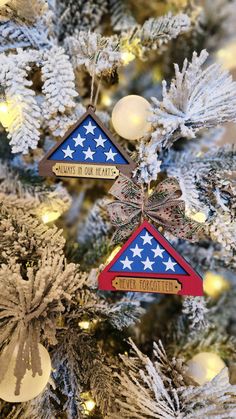 two ornaments are hanging from the christmas tree