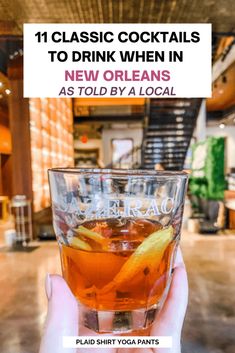 a person holding up a glass with drinks in it and the words, 11 classic cocktails to drink when in new orleans as told by local