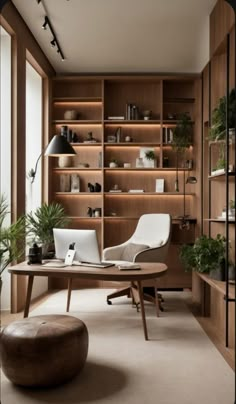 an office with wooden shelves and plants in the corner, along with a round coffee table