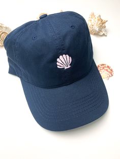 "Embroidered Scallop Seashell Design on Dad Hat Various Hat Colors Various thread colors for Seashell design Classic Dad Hat Fit Hats are: -100% Cotton -Adjustable back strap -Classic brushed gold metal buckle -One size fits most Scallop Seashell 1\" Example Shown: -Navy Blue Hat -Pink Seashell Color options for design slightly vary due to variants in screen display Please feel free to message me with any questions :)" Scallop Seashell, Seashell Design, Ocean Lover, Blue Hat, Beach Hat, Personalized Embroidered, Cute Packaging, Dad Hat, Back Strap