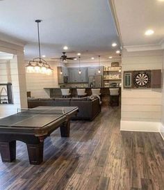 a living room filled with furniture and a ping pong table