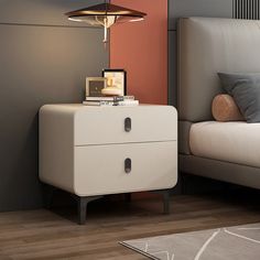 a bedroom with a bed, nightstand and lamp on top of the night stand in front of it