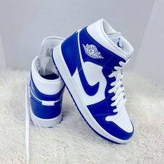 Jordan Brand Is Added A Brand New Colorway Of Their Air Jordan 1 Mid That Comes Dressed In A White And Hyper Royal Color Scheme. This Air Jordan 1 Features A White Tumbled Leather Upper Paired With Hyper Royal Blue Smooth Leather Overlay. Perforated Detailing On The Toe Box, Wings Logo On The Ankle And Jumpman Branding On The Tongues And Insole. Finishing Off The Design Is A White Midsole With A Blue Rubber Outsole. Jordans Nike Air, Air Jordans Blue And White, Blue High Top Nikes, Blue And White Air Jordans, Jordan 1 Bleu, Royal Blue Nike Shoes, Custom High-top Sneakers With Branded Heel, White Sole High-top Jordan Shoes With Branded Heel Counter, Womens Jordans Sneakers