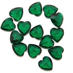 green heart shaped stones on a white background