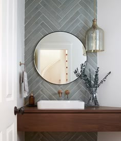 a bathroom with a mirror, sink and shelf