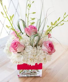 a vase filled with white and pink flowers