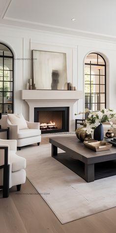 a living room with white furniture and a fire place in the fireplace area is shown