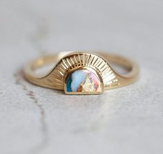 Cyra Oyster turquoise Ring A ring that will accompany you through your day from the sunrise till the sunset. A perfect bohemian style ring. Price is for main ring only. DETAILS  Main Ring   Style: Solitaire  Gemstone: Oyster turquoise  Color: Multicolor  Shape: Half Moon  Cut: Cabochon  Measurements: 7x5 mm  Band   Material: 14k Gold: yellow, white, rose 18k Gold: yellow, white, rose  Other Metal: platinum  Sizing: We are using US metric system  Customization Options This design can be made with gemstones of your choosing. If you would prefer a custom ring, please contact us before purchase. Procedure Information Please select the material, ring size, and finish from the drop-down menu on the right side of the listing. Procedure Information Free Insured Shipping: The item will be gift wrap Wedding Ring Turquoise, Unconventional Wedding Rings, Stone Wedding Rings, Unconventional Engagement Rings, White Opal Engagement Ring, Bohemian Style Rings, Opal Engagement Rings, Sunstone Ring, Silversmith Jewelry