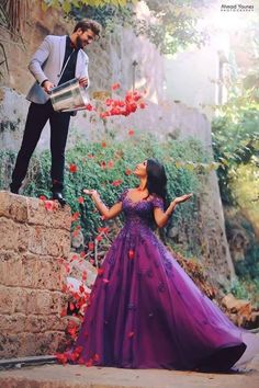 a man standing next to a woman in a purple dress