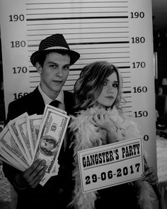 a man and woman posing for a photo in front of a mugshot poster holding money