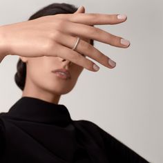 a woman wearing a diamond ring on her finger