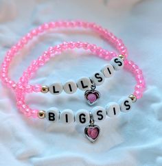 Sweet matching bracelets for your favorite big and little sisters! These pink bead bracelets are made with round acrylic beads and have a small pink heart in the center. The gold accents next to the letters are made with 14k gold plated beads. Bracelets are made of elastic and are slightly stretchy. Please make sure to gently roll on and off bracelets and not overstretch. Bracelets are hand tied and secured with glue.   Each bracelet is sold separately.  Please be sure to measure your child for a proper fit. 💗 Small- 5.5 inches (Lil Sis) Medium- 5.9 inches (available in Lil and Big Sis) Large- 6.2 inches (available in Big Sis) Be sure not to sleep with bracelets or get them wet. Store them properly when not in use. Bracelets For Sisters, Pink Heart Bracelet, Big Sister Little Sister, Lil Sis, Beads Bracelets, Big Sis, Bead Bracelets, Pink Beads, Matching Bracelets