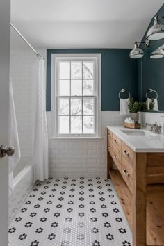 a bathroom with blue walls and white tile on the floor is pictured in this image