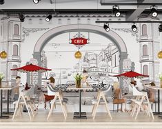 people sitting at tables under umbrellas in front of a wall mural with an open cafe