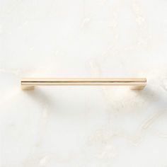 a gold handle on a white marble wall