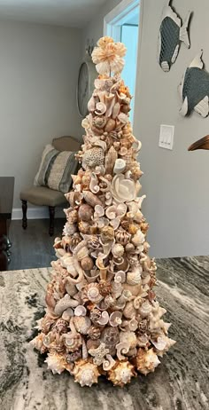 a christmas tree made out of seashells in a living room