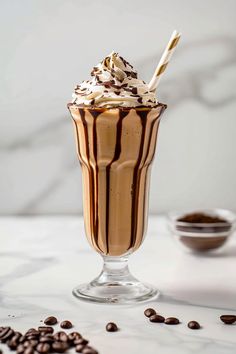 a chocolate milkshake with whipped cream and coffee beans