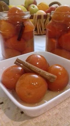 apples in jars with cinnamon stick on table