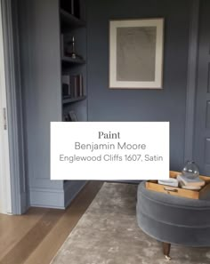 a living room with blue walls and wood flooring is featured in the article paint benjamin moore engelwood cliffs 1087, satin