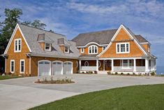 a large house with two car garages on the front and one story above it