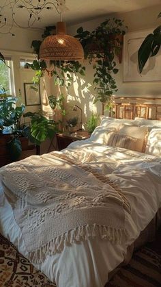 a large bed sitting in a bedroom next to a potted plant on the wall