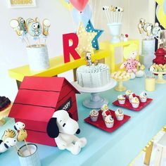 a table topped with lots of cakes and cupcakes