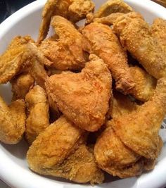 fried chicken pieces in a white bowl on a table