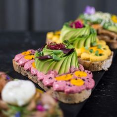 there are many different types of food on the table together, including breads with flowers and leaves