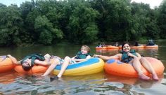 some people are floating on inflatable rafts and having fun with each other