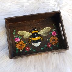 a painted wooden tray with a bee on it