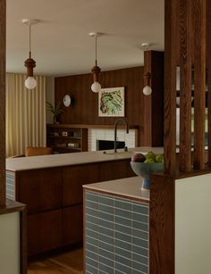 a kitchen with wooden cabinets and white counter tops