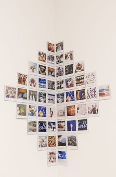 a snowflake made out of photos hanging on the wall in front of a white wall