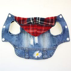 a denim vest with patches and flowers on the inside is made to look like an old jean jacket