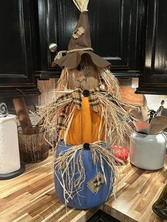 a scarecrow sitting on top of a kitchen counter