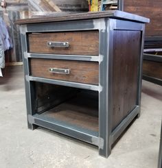 an old wooden cabinet with two drawers on it's sides in a warehouse or workshop