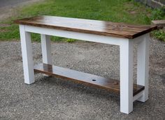 a white bench sitting on top of a gravel road