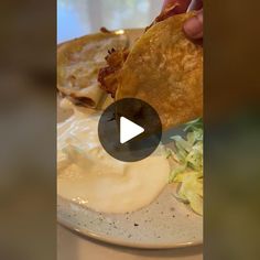 a person is eating some food on a plate with ranch dressing and fried potato wedges