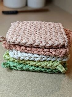 four crocheted blankets stacked on top of each other