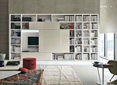 a living room filled with furniture and bookshelves