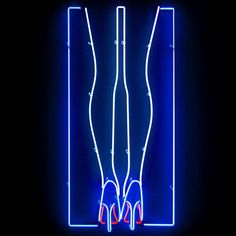 a pair of high heeled shoes in front of a blue neon sign that reads,